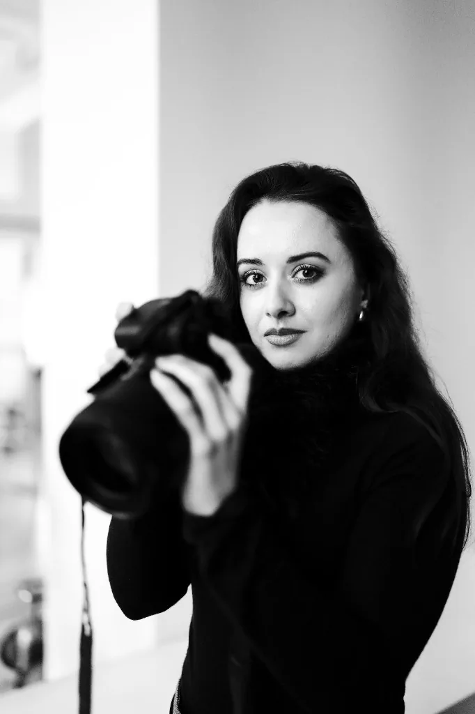 Wedding photographer holding a camera, ready for a studio shoot
